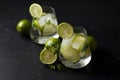 Two fresh glasses of non-alcoholic mojito, against a dark background, on a black table, summer cocktails with lime and mint Royalty Free Stock Photo