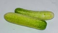 Two Fresh Green Cocumber On White Background.