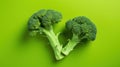 Two fresh heads of broccoli on a vibrant green background, AI-generated. Royalty Free Stock Photo