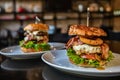 Two fresh juicy burgers with beef, cheese, bacon, onion and salad on a table in a cafe Royalty Free Stock Photo