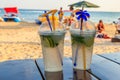 Two fresh mojito cocktails on table on a background of tropical beach Royalty Free Stock Photo