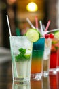 Two fresh mojitos cocktail on wooden background. Mojitos with mint leaves, lime and ice.