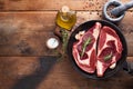 Two fresh raw marble meat, black Angus ribeye steak with spices in iron pan on a old rustic table. Raw beef on a wooden background Royalty Free Stock Photo