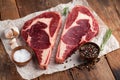 Two fresh raw marble meat, black Angus ribeye steak with spices on a old rustic table. Raw beef on a wooden background. Top view Royalty Free Stock Photo