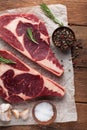 Two fresh raw marble meat, black Angus ribeye steak with spices on a old rustic table. Raw beef on a wooden background Royalty Free Stock Photo