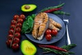 Two fresh raw salmon steaks with vegetables and spices: rosemary, tomatoes, peppers, basil, lemon and olive oil Royalty Free Stock Photo