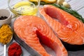 Two Fresh Salmon steaks with seasonings and spices close-up on wooden white table Royalty Free Stock Photo