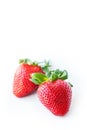 Two fresh strawberries were placed on a white background. Copy space