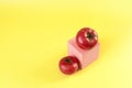 Two fresh tomatoes and a pink podium Royalty Free Stock Photo