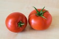 Two fresh tomatoes on wooden table. Royalty Free Stock Photo