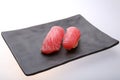 Two fresh tuna sushi on a black dish Royalty Free Stock Photo