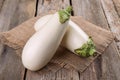 Two fresh white eggplants on wooden table Royalty Free Stock Photo