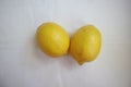 Two fresh yellow lemons at whire background