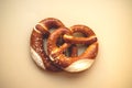 two freshly baked pretzels close-up, isolated on a beige background Royalty Free Stock Photo