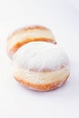 Two freshly made doughnuts filled with jam and covered in powdered sugar Royalty Free Stock Photo