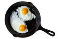 Two fried eggs in cast iron frying pan isolated on white from ab Royalty Free Stock Photo