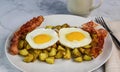 two fried eggs on home fries and bacon Royalty Free Stock Photo