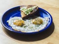 Two fried eggs sunny side up egg on blue ceramic plate Royalty Free Stock Photo