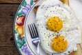 Two fried eggs on toast in plate on wooden table Royalty Free Stock Photo