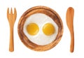 Two fried eggs on wooden plate, knife and fork isolated on white Royalty Free Stock Photo