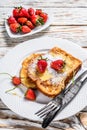 Two fried French toast with powdered sugar and strawberries. White background. Top view Royalty Free Stock Photo