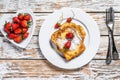 Two fried French toast with powdered sugar and strawberries. White background. Top view Royalty Free Stock Photo