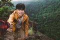 Two friend hiking with Backpack, His hand grabbed the friend in front of him as he walked up the hill