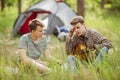 Two friend sitting in the tent, play the guitar and sing songs Royalty Free Stock Photo