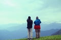 Two friend watching mountain range and waiting for sunrise