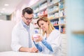 Two pharmacists working in a drugstore. Royalty Free Stock Photo