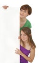 Two friendly young women holding a blank banner ad Royalty Free Stock Photo