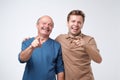 Two friends in casual colorful wear standing and laughing together. Best friends enjoying life. Two men having fun.