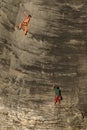 Two friends climbing sandstone rock