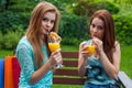 Two friends drink refreshing, cold orange juice. Royalty Free Stock Photo