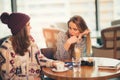 Two friends enjoying coffee together in a coffee shop Royalty Free Stock Photo