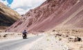 Two friends go by motorcycle by the Leh - Manali highway in high Himalayas Mountain, India