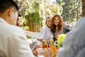 Two friends are having fun at a picnic table. A blonde and a redhaired girl are hugging on a picnic in the forest Royalty Free Stock Photo