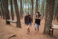 Two friends hiking in pine wood forrest