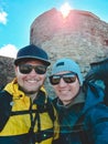 two friends hikers taking selfie at mountains peak