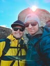 two friends hikers taking selfie at mountains peak