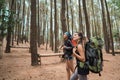 Two friends hiking in pine wood forrest