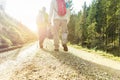 Two friends hiking in switzerland at sunrise - Young people walking in mountain trails with sun back light - Trekking and healthy