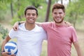 two friends holding volleyballsmiling at camera Royalty Free Stock Photo