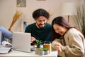 Two friends laughing while studying together at home. Royalty Free Stock Photo