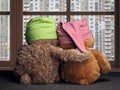 Two friends looking out the window at the windows of the house. Toys colorful hats bear cubs. Embrace the . Concept - love,