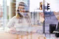 Two Friends Looking At Smartphone In Cafe seen through window Royalty Free Stock Photo