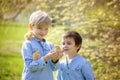 Two friends in the park, playing with cute newborn chicks Royalty Free Stock Photo