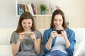 Two friends playing online games with smartphones