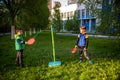 Two friends are playing tetherball swing ball game in summer camping. Two boy brother happy leisure healthy active time outdoors