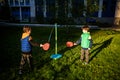 Two friends are playing tetherball swing ball game in summer camping. Two boy brother happy leisure healthy active time outdoors